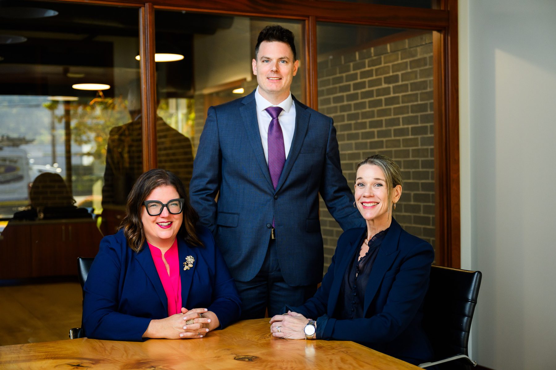 Anne Foster, Sam Smith, and Jaimee King of Smith Foster King at a conference table